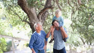 Father, son and grandfather spending time together outside.