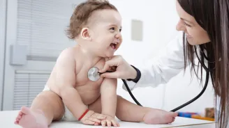 Happy baby visiting the pediatrician 
