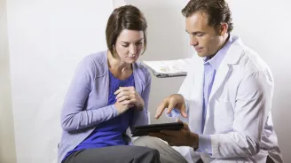 Woman reviewing chart with her doctor