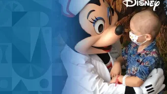 Minnie Mouse dressed a nurse with a child patient wearing a mask