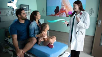 A Doctor Speaks to a Family at AdventHealth ER at FLAMINGO CROSSINGS Town Center