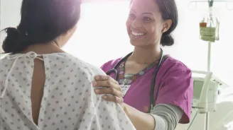 A Nurse Speaks to a Patient with Happy News