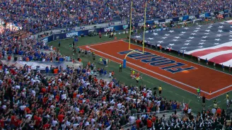 In the stands, looking over as the American flag is stretched over the field at Camping World Stadium.