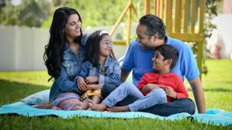 A Family Enjoys a Picnic in Their Backyard