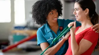A Therapist Helps a Patient Through a Orthopedic Physical Therapy Session.