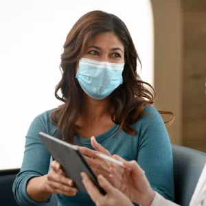 A Woman Consults With Her Doctor with a Tablet.