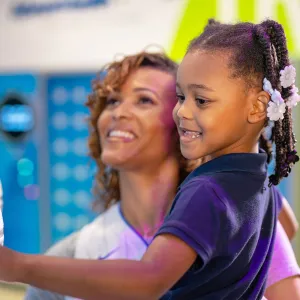 A Woman Hold Her Daughter in the Gift Shop of The Amway Center