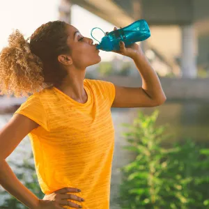 Woman on a run drinking water