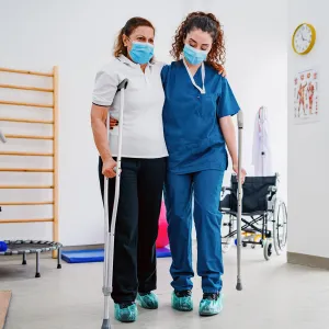 A Physical Therapist Helps a Patient During a Session.