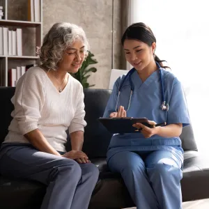 A Doctor and Her Patient Sit in an Office an Talk about Her Charts.