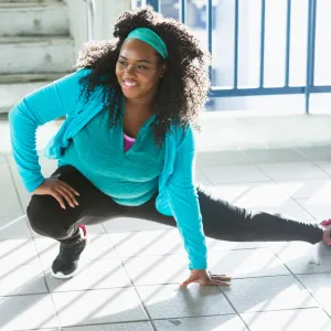 A Woman Stretches Before Going For a Run