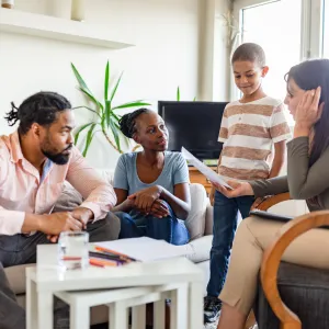 Two Parents and a Child Speak to a Mental Health Professional