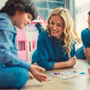 A Family Plays a Board Game Together at Home.