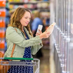 A woman reading product labels at the store