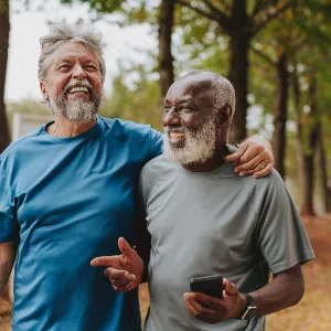 Two older men walking outdoors together.