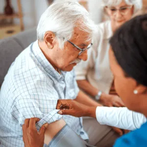 A Senior Man Has His Blood Pressure Taken by a Medical Professional