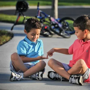 Kids Playing on Sidewalk with Bikes