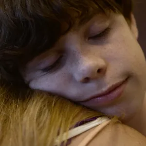Cory and her son in an embrace.