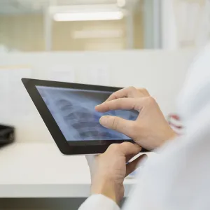 Close-up of a physician examining an x-ray.