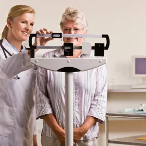Woman on a scale at a doctor's office