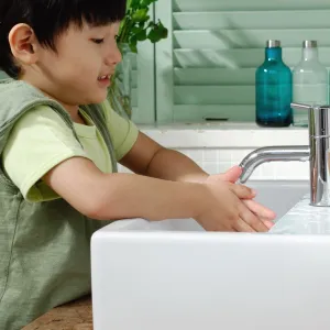 Little boy washing his hands