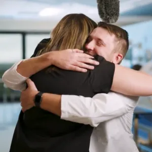 AdventHealth nurse Delaney Postma and UCF student Maxwell Jones hug, after seeing each other for the first time since Jones was accepted into the College of Nursing.