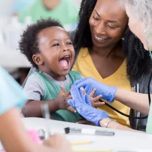Nurse Taking Care of a Happy Baby