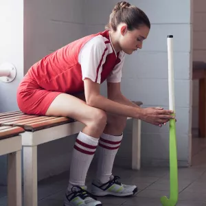 A teenage athlete taking a break in the locker room.