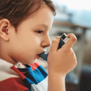 A child using an inhaler.