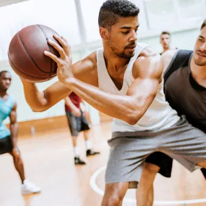 A group of young men playing basketball