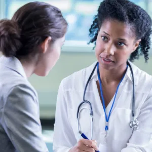 Woman talking to her doctor about getting a mammogram