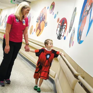 Boy wearing an iron man hospital gown with