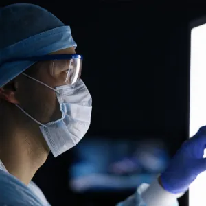 Physician looking at medical imaging scans