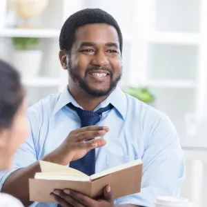 A CPE Pastor Reads the Bible to a Patient