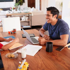 Dad working from home with his son