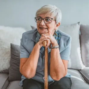 A woman sitting on her couch thinking.