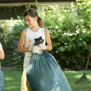 A family cleans up the lawn together.