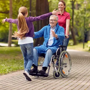 A multi-generational family enjoys time together in a park.