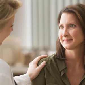 A doctor giving her patient words of strength as they talk