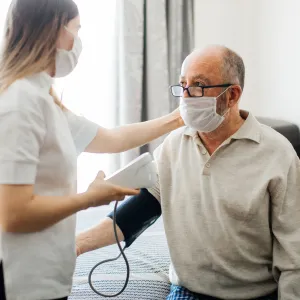 A man getting his blood pressure checked at the doctor.
