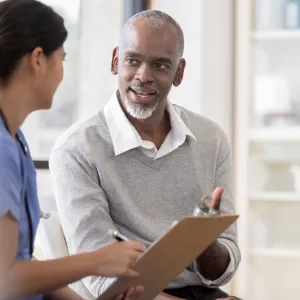 A man discussing his care with his doctor.