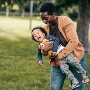 A mom and child playing outside.