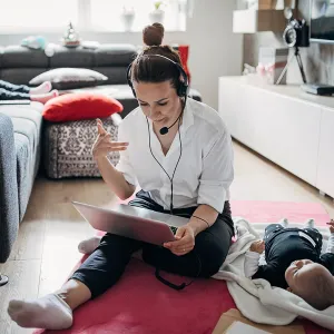 Woman working from home while she's with her children.