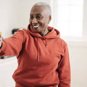 A mature woman exercising at home.