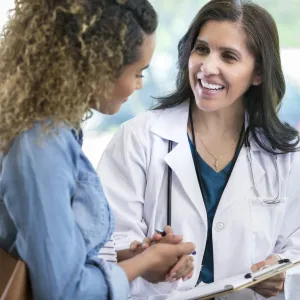 A woman discusses study results with her doctor.