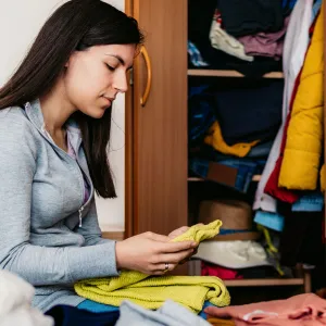 a woman donates her clothing