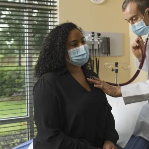 A woman having an exam by a doctor.