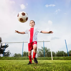 A young boy about to kick a soccer ball.