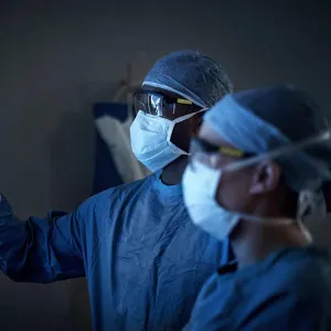 Doctors with masks looking at X-Ray
