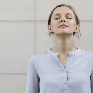 A woman takes a deep breath to stay calm during a lab test